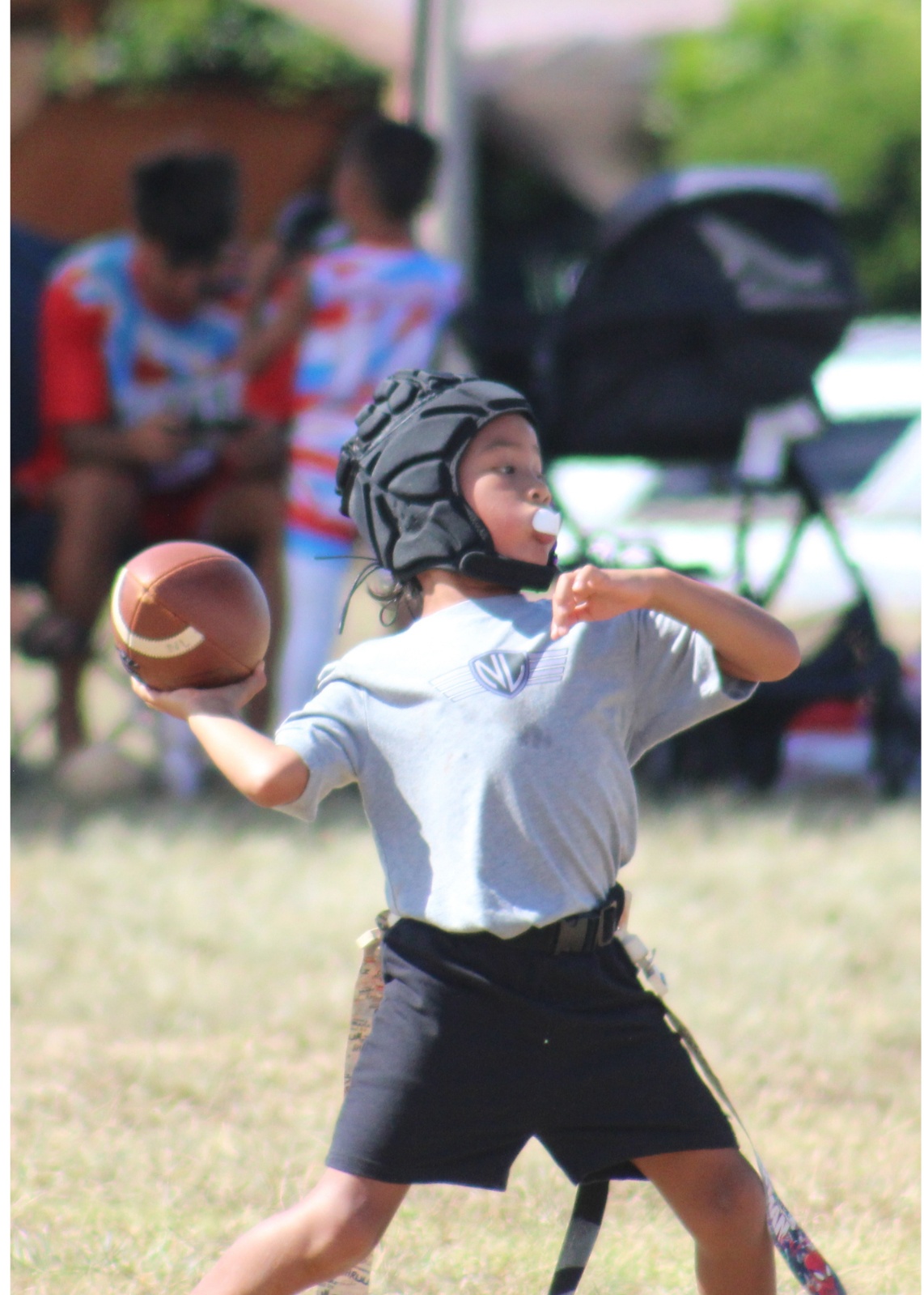 Pearl City Junior Chargers flag football player passing the ball