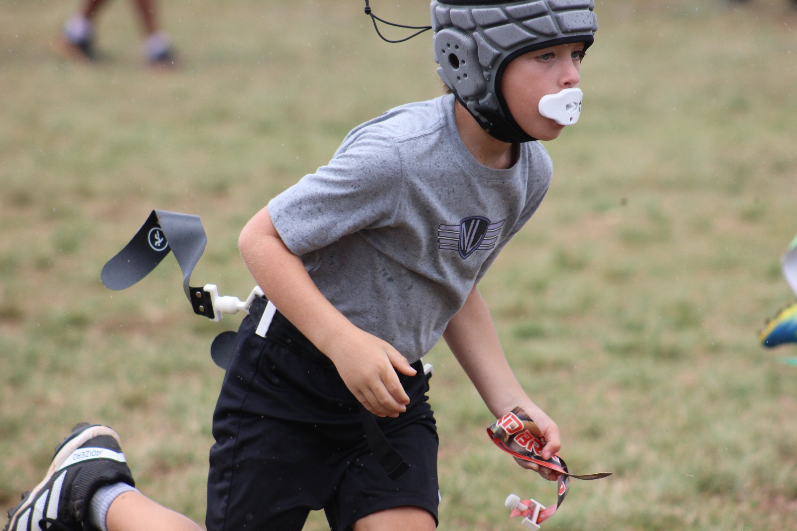Pearl City Junior Chargers player reaching for a flag